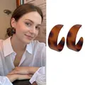 Retro amber tortoiseshell C-shaped resin hoop earrings shown on model and white background - Thick C-Shape Coffee Tortoiseshell (7# Silver Needle)