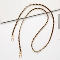 Detail of black leather and gold metal interwoven chain strap with lobster clasps - Coffee