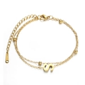 Double-layered golden stainless steel bracelet featuring round beads and letter S charm - S