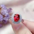 Silver-colored ring featuring an oval red gemstone surrounded by white zircons on hand - Platinum [ruby] Ljz-274 / Adjustable Open