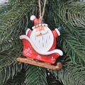 Christmas tree ornament featuring Santa Claus on a sleigh with festive red and white details - Red Sleigh Santa Claus