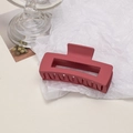 Detail of matte dark red large hair claw clip on white crinkle paper background - Cube / Raspberry Pink