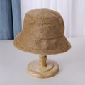 Brown fluffy faux fur bucket hat displayed on a wooden stand for winter fashion - 56-58cm / Khaki