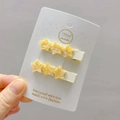 Close-up of yellow glitter star hair clips on a white card for girls hair styling - 14# Yellow Star Pair Clips