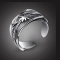 Close-up of vintage silver octopus tentacle ring with feather texture and star motif - Feather