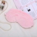 Soft pink plush sleep eye mask with satin strap on a decorative lifestyle background - Pink