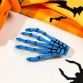 Close-up of a glossy blue skeleton hand hair clip with black detailing for Halloween - Sapphire Blue