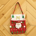 Detail of red burlap Christmas gift bag with Santa Claus motifs and golden bow decoration - Red Santa Claus