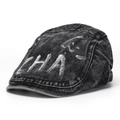 Close-up of vintage washed denim newsboy cap with white graffiti text and stitching - Style B-Washed Black (CHA)