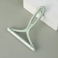 Manual lint remover with light green ergonomic handle and dual silicone scraper - Light Green