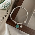 Silver bead bracelet featuring white pearls and a green enamel smiley face charm - Smiley Artificial Pearl Beaded (SL0748)