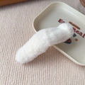 Close-up of a white plush hair clip on a decorative tray showing its soft fuzzy texture - Basic Style / White