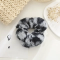 Detail of plush faux fur hair scrunchie with soft grey and black texture in cozy setting - Grey & Black Faux Fur
