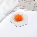 Detailed close-up of a fluffy orange faux fur mink ball charm on a hexagonal base - Orange