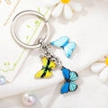 Detailed view of silver alloy keychain with three colorful enamel butterfly charms - Style 10 M748 (Silver Ring Blue/Yellow Butterfly)