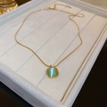 Titanium steel gold necklace with a square green opal pendant on a beige jewelry tray - Green Square (3# Necklace)