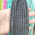 Close-up of black lava stone spacer beads showing natural porous texture for DIY jewelry - Lava Stone