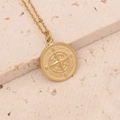 Detailed close-up of golden compass pendant necklace with N S E W engravings on stone - Round Compass (4#)