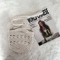 Close-up of beige crochet cotton shoulder bag with woven texture on plush rug - White