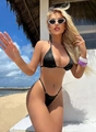 Sparkly black triangle bikini set with halter top and high cut bottoms on beach - Black