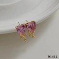 Pink heart zircon stud earrings with gold melting detail on white ceramic tray - Gold Earrings + Pink Zircon (D1412)