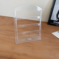 Transparent acrylic earring organizer stand with 4 tiers and top hook on wood surface - Clear