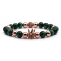 Detail of beaded bracelet with rose gold crown charm, tiger eye and matte black stones - Green Tiger Eye Rose Gold