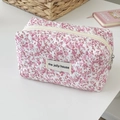 Floral quilted makeup bag in cream with pink flowers and a metal ring zipper pull - Pink Floral