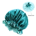 Detail view of reversible double-layer satin bonnet in dark green and light blue colors - One Size / Peacock Blue