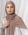 Elegant solid brown pearl chiffon long scarf hijab worn by model in soft light - Camel