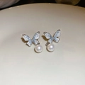 Macro view of silver butterfly earrings with crushed ice texture and pearl drops - 925 Sterling Silver Earring Post Silver Butterfly Pearl Style