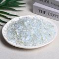 Polished opal chip stones in a ceramic dish with vibrant blue and green color play - 100g Of Synthetic Opal (7-9mm)