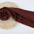 Chiffon pearl hijab scarf in dark burgundy with fine rolled edges on straw mat background - 120