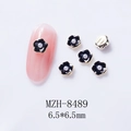 Close-up of 6.5mm black 3D flower nail charm with pearl center on pink manicure - Black Flower with Pearl (8489)