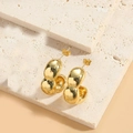 Detailed close-up of 14K gold plated bamboo minimalist double ball stud earrings on stone - Bamboo Large Gold