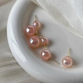 Elegant pink mermaid pearl earrings in various sizes on a white ceramic display plate - Iridescent Pink/Round/14mm