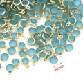 Macro detail of 6mm blue crystal birthstone pendants with gold stainless steel frames - Sky Blue