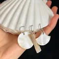 Three-piece set of natural shell earrings in round, bar, and fan shapes with silver hoops - Shell Notebook with Shell Tassel