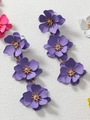 Detail shot of purple 3D flower drop earrings with golden core on white background - Purple