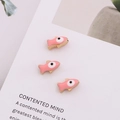 Detailed view of pink enamel fish charms with gold plating and evil eye beads - Pink