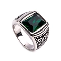 Macro shot of a vintage silver ring featuring a square emerald-cut green gemstone with floral patterns - Steel Color Dark Green Gemstone