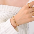 Minimalist 18K gold plated stackable chain bracelet and rings set shown on a model - Gold Geometric Bracelet Accessory-E308