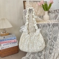 Close-up of floral tote bag with lace edges, ruffles, and a decorative ribbon bow - Jacquard Yellow Cherry