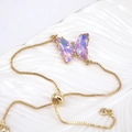 Detail of gold box chain bracelet with adjustable bead and purple rhinestone butterfly - Lavender