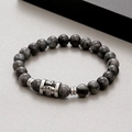 Macro shot of tiger eye beads and silver skull charm on an elastic beaded bracelet - Gray Stone (KB183251-TLX)