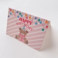 Close-up of pink mini birthday card featuring a cute cartoon bear and happy birthday text - Happy Birthday Bear