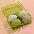 Green storage case containing four water-drop shaped makeup sponges in assorted green tones - 4Pcs Makeup Sponges [Green]