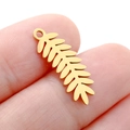 Delicate gold hollow leaf pendant charm shown on a fingertip for realistic size scale - DY749 Fern Leaf / Gold