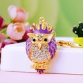 Golden owl keychain with purple crystals and crown detail on a floral background - A430 Owl F Purple