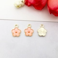 Three orange enamel flower pendants with gold metal frames and textured back views - Small Flower (14796)